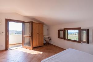 a bedroom with a bed and a large window at Villa Zagara in Partinico +24 photos