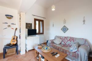 a living room with a couch and a table at Villa Zagara in Partinico