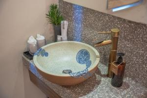 a bowl sink on a counter in a bathroom at Sojourn Spa Hotel Kuala Lumpur in Kuala Lumpur +47 photos