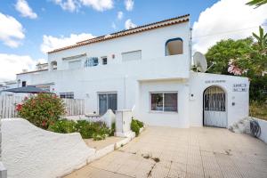 a white house with a ramp in front of it at Isabel apartment in Carvoeiro