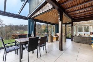 an open dining room with a table and chairs at Panoramaferienhaus Sorpesee, 120qm in Sundern
