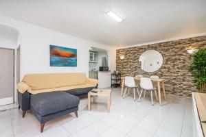 a living room with a couch and a table at Isabel apartment in Carvoeiro