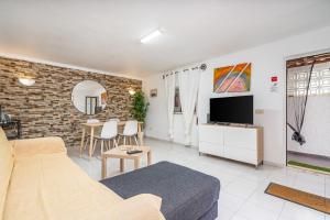 a living room with a couch and a tv at Isabel apartment in Carvoeiro