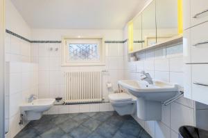 a bathroom with a sink and a toilet and a window at Panoramaferienhaus Sorpesee, 120qm in Sundern +31 photos