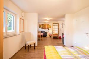 a bedroom with a bed and a living room at Ferienhof Weber Wohnung Fichte in Neukirch