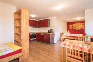 a kitchen and a living room with two bunk beds at Ferienhof Weber Wohnung Fichte in Neukirch