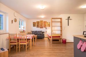 a living room with a table and chairs and a couch at Ferienhof Weber Wohnung Fichte in Neukirch +16 photos