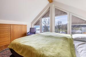 a bedroom with a bed and a large window at Panoramaferienhaus Sorpesee, 120qm in Sundern