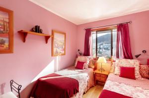 a bedroom with two beds and a window at Bungalow Flores with view in Puerto Rico de Gran Canaria +17 photos