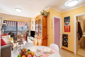 a living room with a table with fruits on it at Bungalow Flores with view in Puerto Rico de Gran Canaria