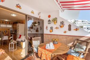 a dining room with a table and chairs at Bungalow Flores with view in Puerto Rico de Gran Canaria