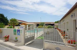 a gate leading to a pool in a building at Studio à La Ferme in Sémussac +12 photos