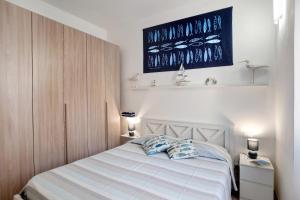 a bedroom with a bed with two pillows on it at Casa di Ali in Imperia