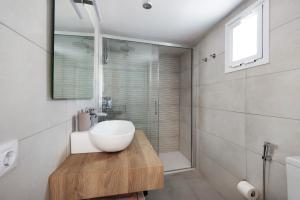 a bathroom with a white sink and a shower at Casa Sol 21 B Garachico in Garachico +20 photos