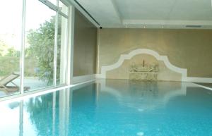 a swimming pool with a fireplace in a room at Hotel Palacio Urgoiti in Mungia