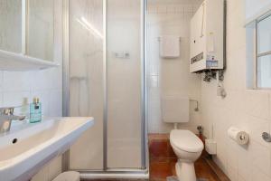 a bathroom with a shower and a toilet and a sink at Ferienhaus Jadeblick I I in Dangast +22 photos