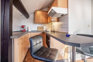 a small kitchen with a table and chairs at Haus Ostseesonne in Baabe