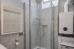 a bathroom with a shower with a glass door at Haus Ostseesonne in Baabe +14 photos