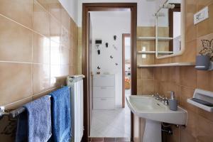 a bathroom with a sink and a toilet and a mirror at Da Ercolino in Pitelli