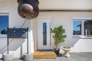 a front door of a white house with a plant at Apartments Winder 1 in Lustenau