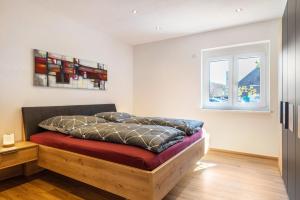 a bed in a room with a window at Apartments Winder 1 in Lustenau