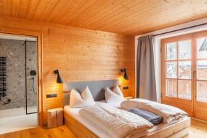 a bedroom with a bed in a wooden wall at Chalet Flocke Appart Murmeltier in Sankt Anton am Arlberg