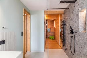 a bathroom with a shower and a glass door at Chalet Flocke Appart Murmeltier in Sankt Anton am Arlberg +21 photos
