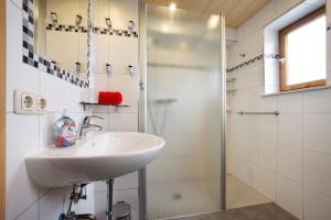 a bathroom with a sink and a shower at Ferienhaus Hilde in Schwangau +19 photos