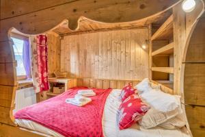 a bedroom with a bed in a wooden wall at Anna-purna in Arâches-la-Frasse