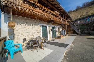 a patio with a table and chairs outside of a building at Anna-purna in Arâches-la-Frasse