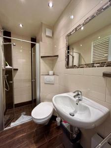 a bathroom with a sink and a toilet and a mirror at 208 im Lord Nelson in Cuxhaven +12 photos