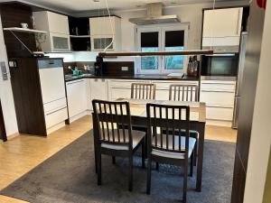 a kitchen with a table and chairs and a refrigerator at Ferienhaus Frank Grieser in Hopferau