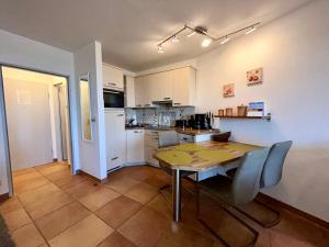 a kitchen and dining room with a table and chairs at 208 im Lord Nelson in Cuxhaven