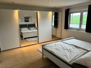 a bedroom with a mirror and a bed in it at Ferienhaus Frank Grieser in Hopferau