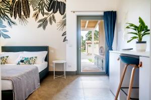 a bedroom with a bed and a sliding glass door at Casale Lorenzo Appartamenti in Orbetello