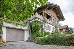 a house with a garage in front of it at Haus Verdandi in Sibratsgfäll