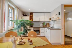 a kitchen with white cabinets and a table with eggs on it at Haus Verdandi in Sibratsgfäll