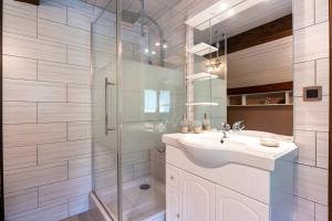 a white bathroom with a sink and a shower at Chalet Le Grand Nant in La Giettaz +18 photos