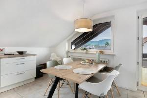 a kitchen and dining room with a wooden table and chairs at Fewo Worb in Rielasingen-Worblingen