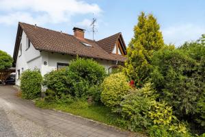 a white house with a brown roof at Fewo Worb in Rielasingen-Worblingen