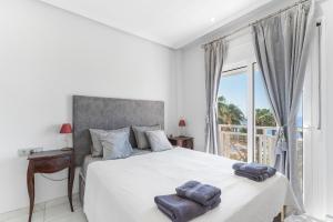a bedroom with a bed and a large window at Casa del Sol Premium Cabo Roig in Orihuela +18 photos
