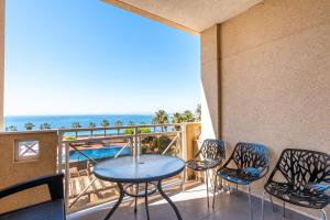 a balcony with a table and chairs and the ocean at Casa del Sol Premium Cabo Roig in Orihuela