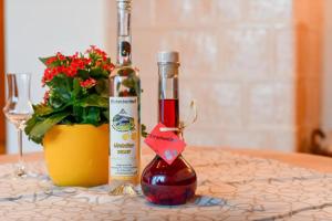 a bottle of wine on a table next to a flower pot at Rinkenbachhof in Schenkenzell +20 photos