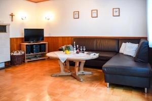 a living room with a table and a couch at Rinkenbachhof in Schenkenzell