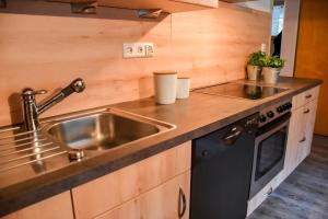a kitchen with a sink and a stove at Rinkenbachhof in Schenkenzell