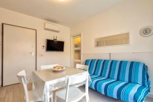 a living room with a table and a blue couch at Villafranca in Alghero