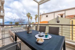 a table with a bowl of food on a balcony at Villafranca in Alghero