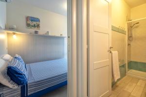 a small bedroom with a bed and a shower at Villafranca in Alghero +16 photos