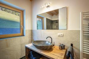 a bathroom with a sink and a mirror at Kreuzplonhof Apt Dorfblick in Luson