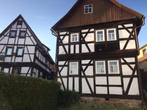 two black and white buildings next to each other at Logierhaus An der Truse in Brotterode